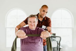 A therapist helping a patient with a physical therapy appointment